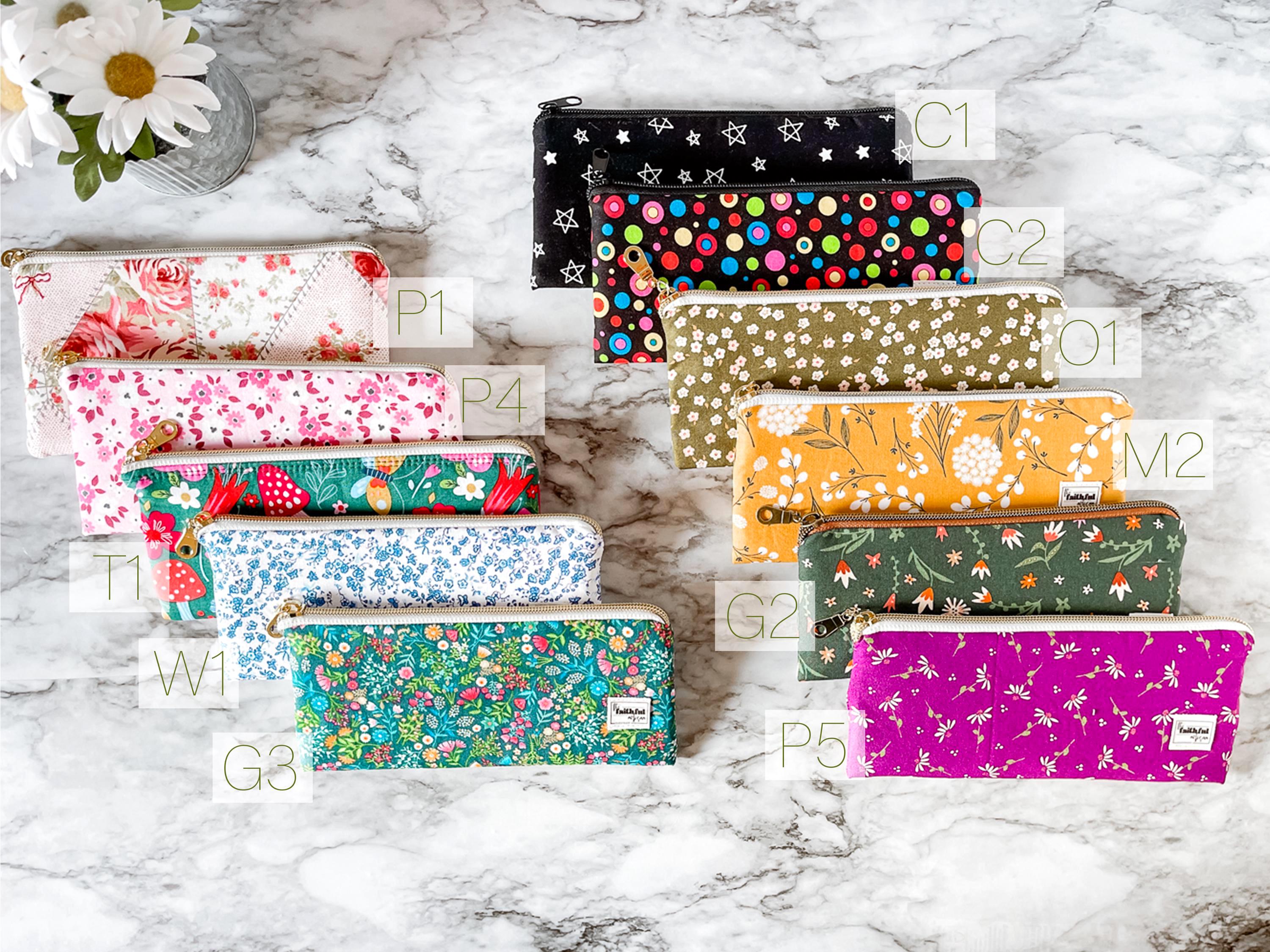 Collection of colorful patterned pouches on a marble surface
