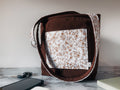 Brown corduroy with floral front slip pocket mini tote shoulder bag on a marble surface