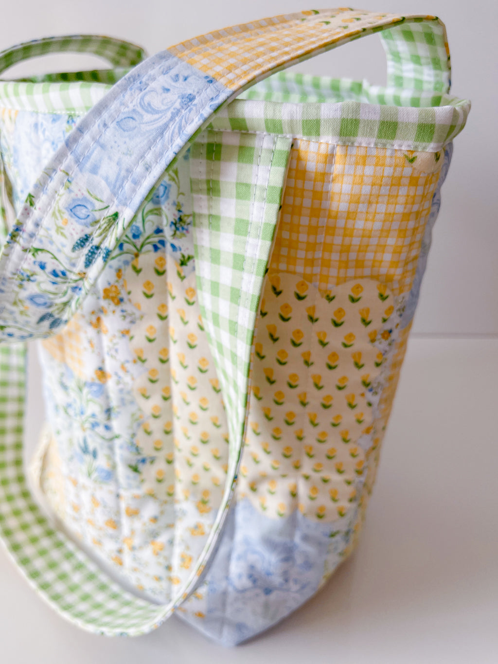 Patchwork fabric bag with colorful patterns on a white background